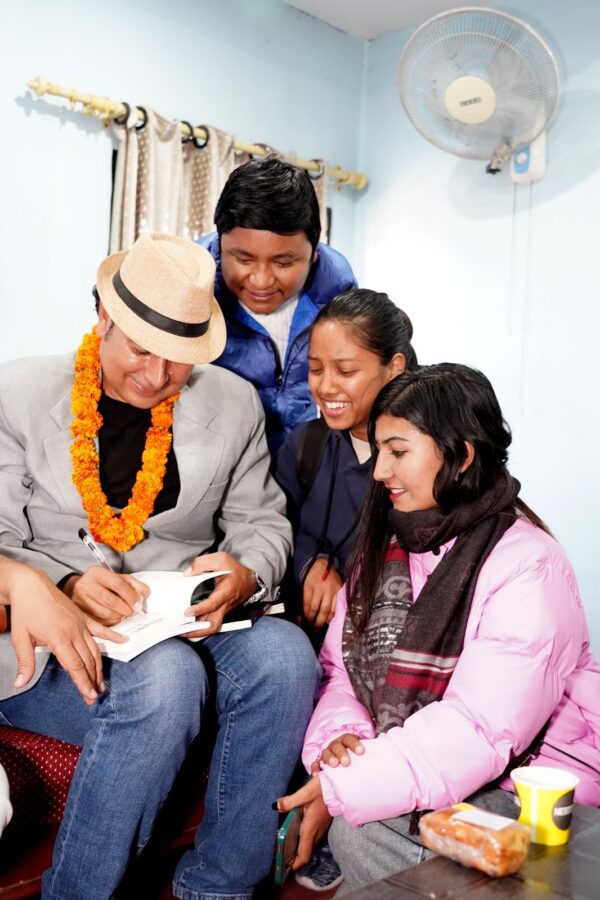 Poet Bhupeen signing his novel Maidaro after its launch event in Nepal. Photo by Mahendra Ojha. Used with permission.